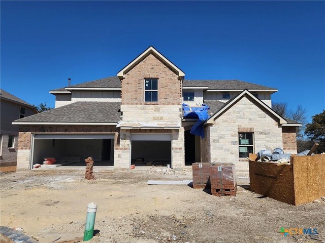 view of front of house featuring a front lawn and a garage