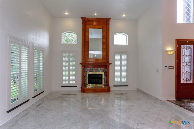 2110 Lakeview Loop, Killeen, TX 76543 - unfurnished living room with a fireplace, a towering ceiling, marble finish floor, and baseboards