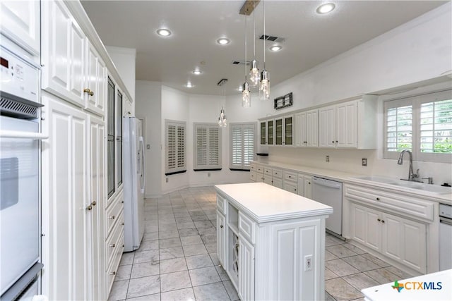 2110 Lakeview Loop, Killeen, TX 76543 - kitchen featuring a center island, white appliances, white cabinets, and a sink