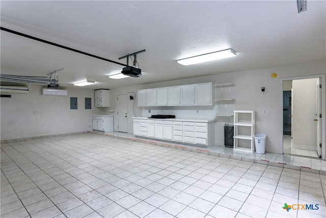 2110 Lakeview Loop, Killeen, TX 76543 - garage with baseboards, a garage door opener, and electric panel
