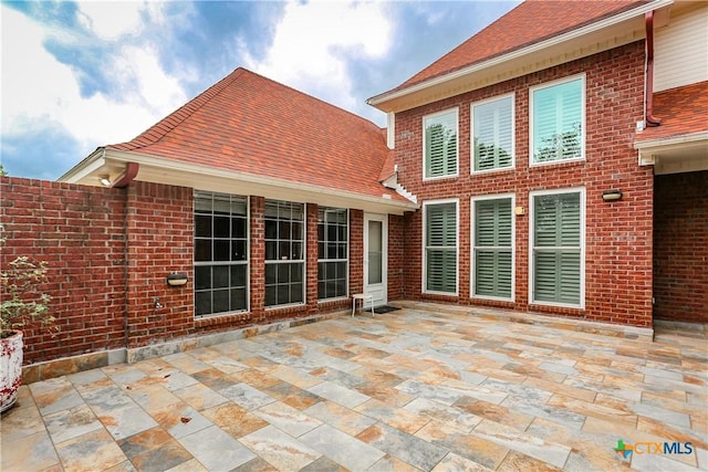 2110 Lakeview Loop, Killeen, TX 76543 - back of house featuring brick siding, roof with shingles, and a patio area
