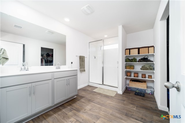 bathroom featuring walk in shower, vanity, and hardwood / wood-style flooring