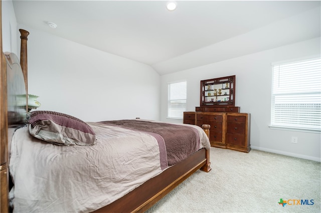 bedroom featuring vaulted ceiling and light colored carpet