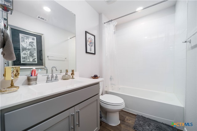 full bathroom with toilet, wood-type flooring, vanity, and shower / bathtub combination with curtain