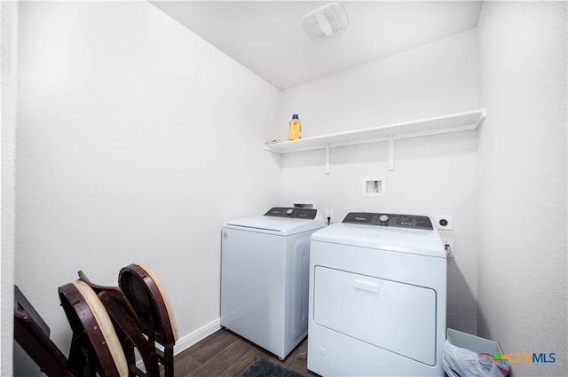 washroom featuring dark wood-type flooring and washer and clothes dryer