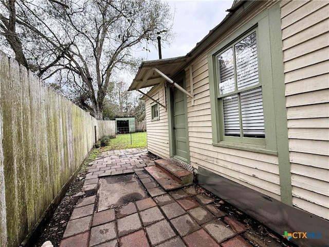 view of side of home with a patio area