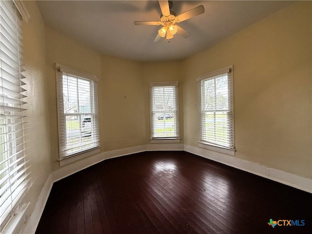 spare room with hardwood / wood-style floors and ceiling fan