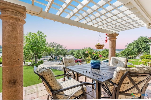 view of patio featuring a pergola and outdoor dining area