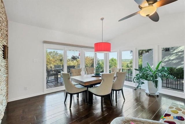 dining area featuring vaulted ceiling, dark wood-type flooring, ceiling fan, and french doors