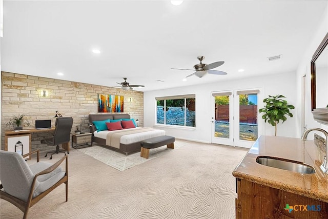 bedroom featuring recessed lighting, access to exterior, visible vents, light carpet, and a sink