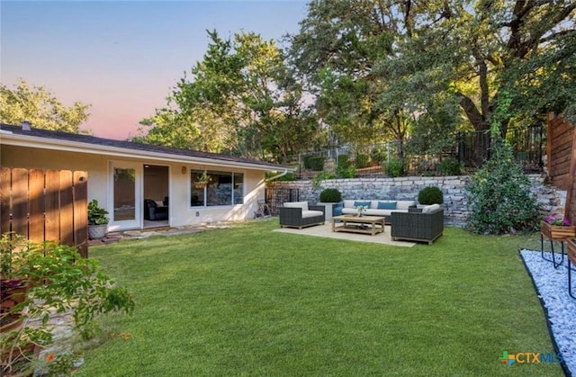 yard at dusk featuring a patio and outdoor lounge area