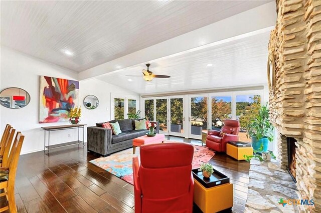 living area with hardwood / wood-style flooring, a fireplace, ceiling fan, and a healthy amount of sunlight