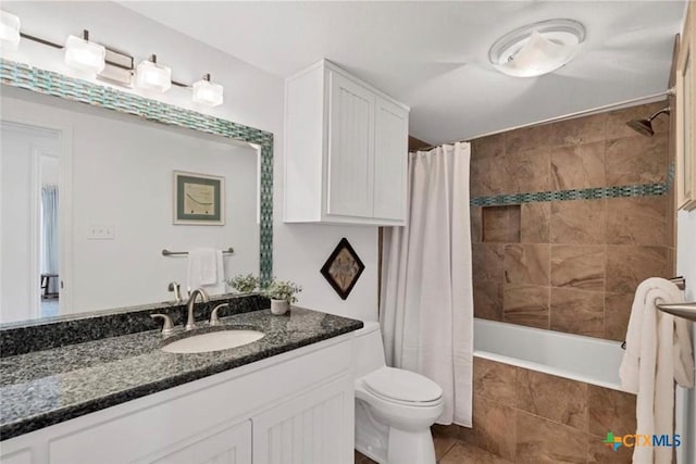 full bathroom with toilet, tile patterned floors, vanity, and tiled shower / bath combo