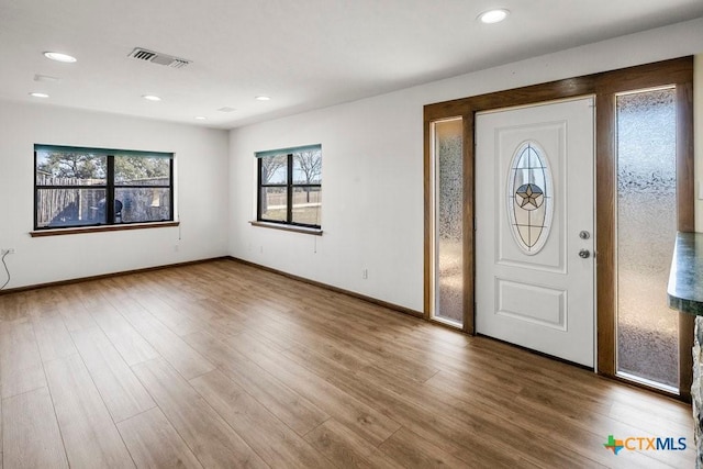 foyer entrance with recessed lighting, visible vents, baseboards, and wood finished floors