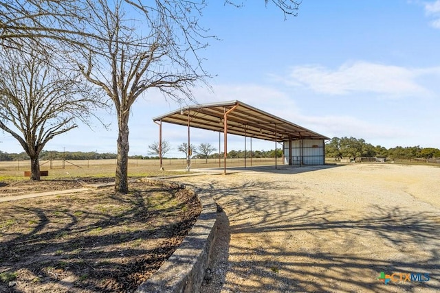 view of community featuring driveway and an outdoor structure