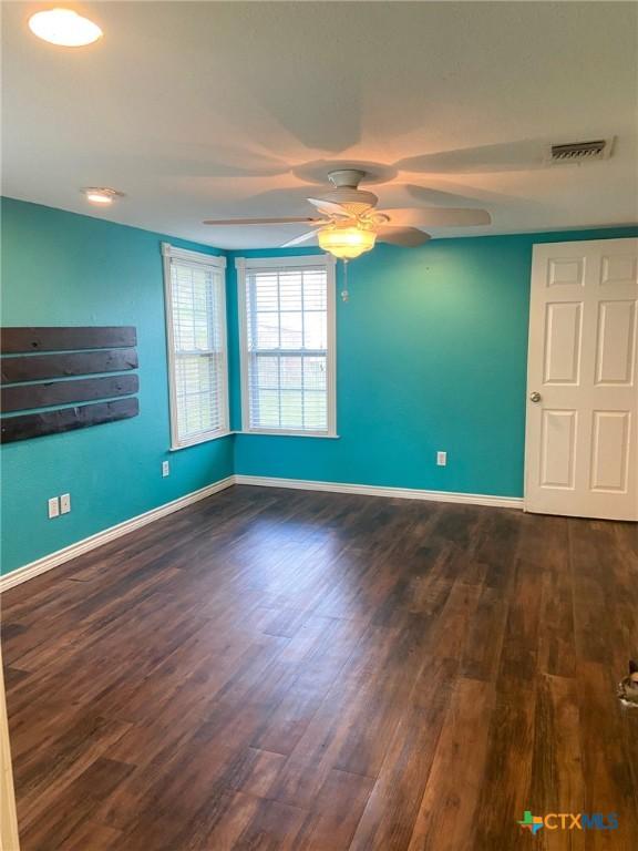 3514 Old Goliad Rd, Victoria, TX 77905 - spare room featuring a ceiling fan, wood finished floors, and baseboards