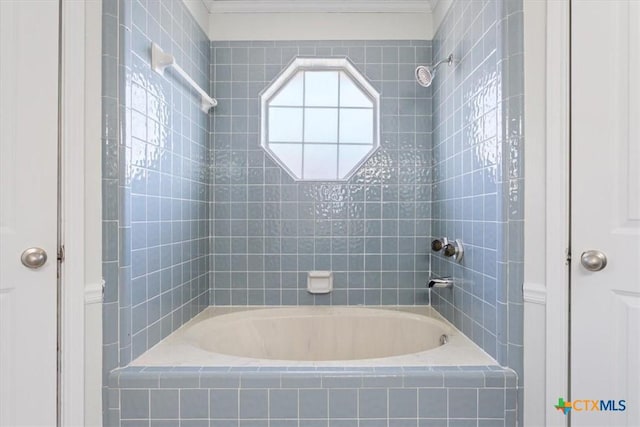 bathroom with tiled shower / bath combo and ornamental molding