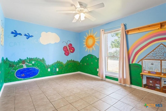 rec room with ceiling fan and tile patterned flooring