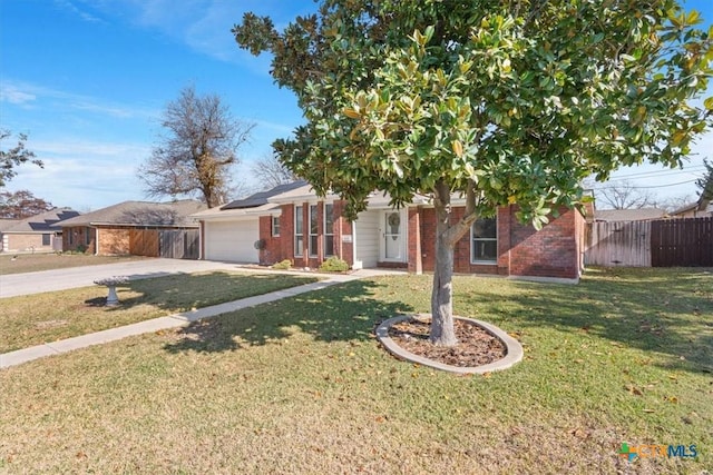 view of front of property featuring a garage and a front lawn