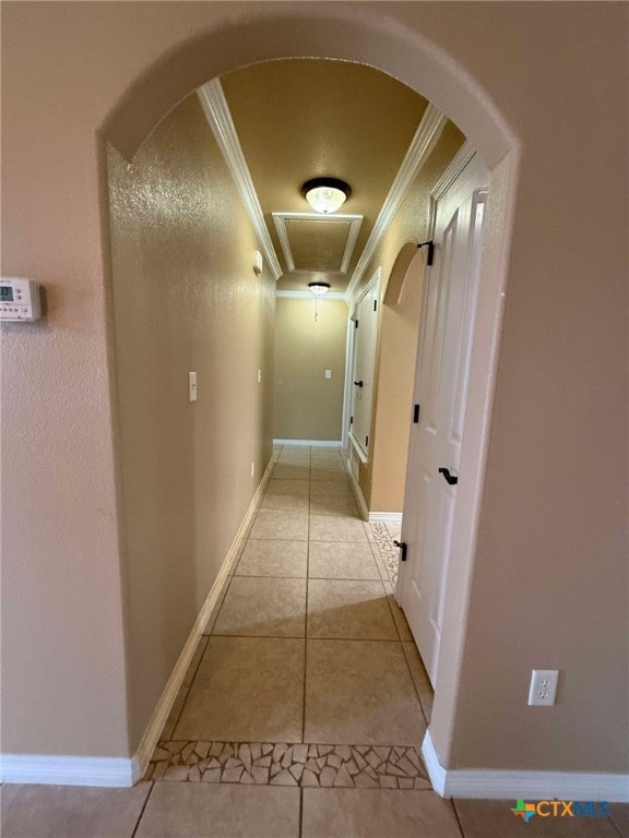 corridor with light tile patterned floors and ornamental molding