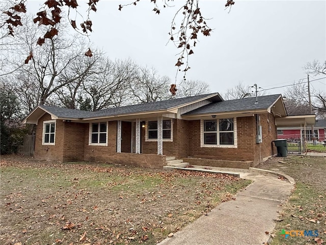 single story home featuring brick siding and fence