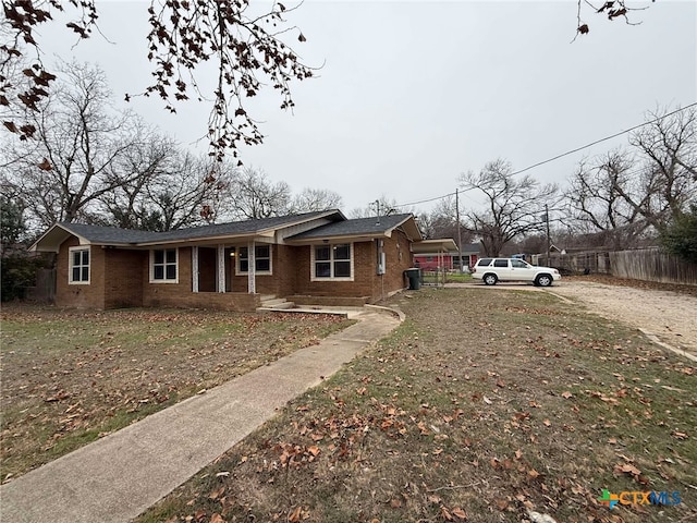 view of front of property featuring brick siding and fence