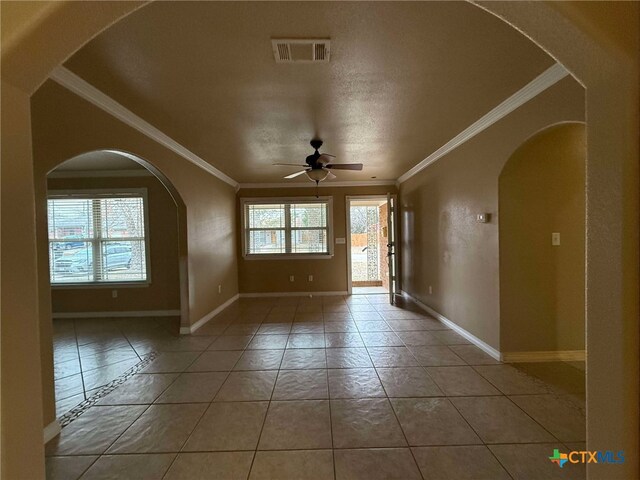 corridor with crown molding and light tile patterned flooring