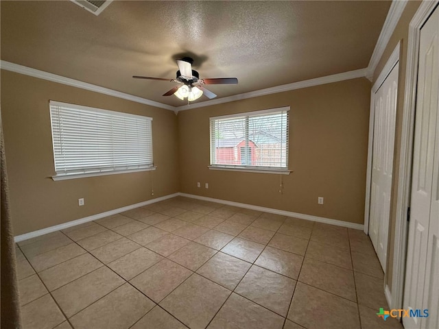 unfurnished bedroom featuring crown molding, light tile patterned floors, ceiling fan, and a textured ceiling