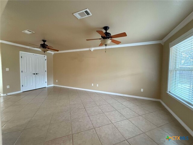 hall with crown molding and light tile patterned floors