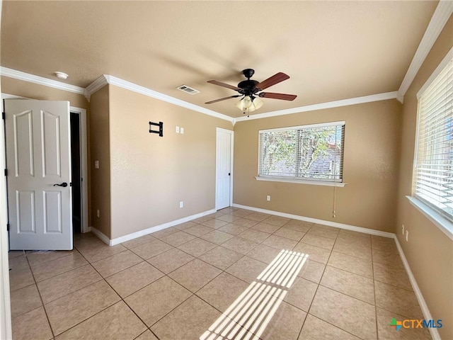 tiled spare room with ornamental molding and ceiling fan