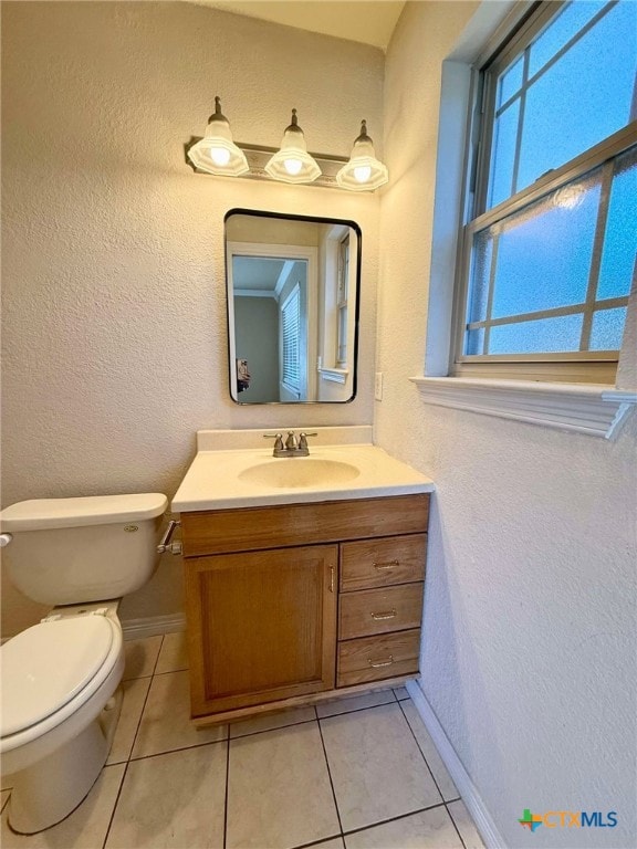 bathroom with vanity, tile patterned floors, and toilet