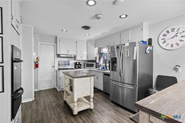 4811 Lilac Ln, Victoria, TX 77904 - kitchen featuring appliances with stainless steel finishes, recessed lighting, a warming drawer, dark wood-style flooring, and white cabinetry