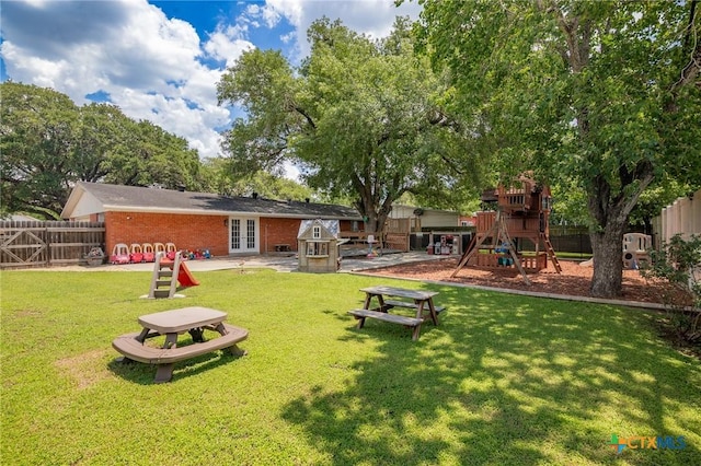 4811 Lilac Ln, Victoria, TX 77904 - back of property with french doors, a playground, and brick siding