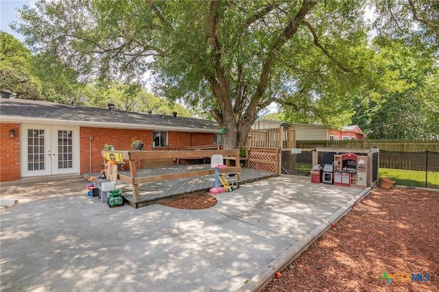 4811 Lilac Ln, Victoria, TX 77904 - view of patio / terrace featuring french doors, fence, and a deck