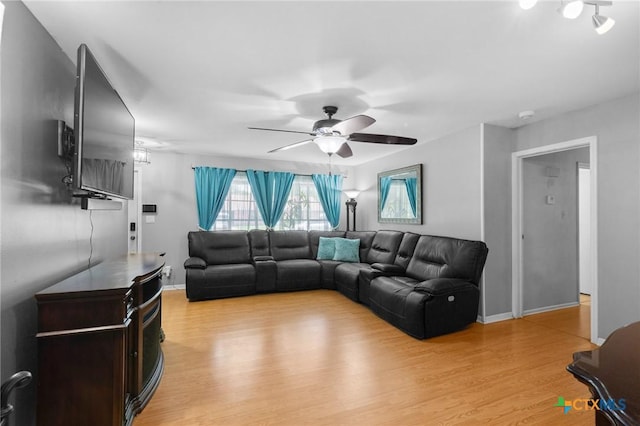 4811 Lilac Ln, Victoria, TX 77904 - living area featuring light wood finished floors, a ceiling fan, and baseboards