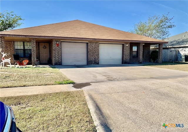 ranch-style house with a garage and a front yard