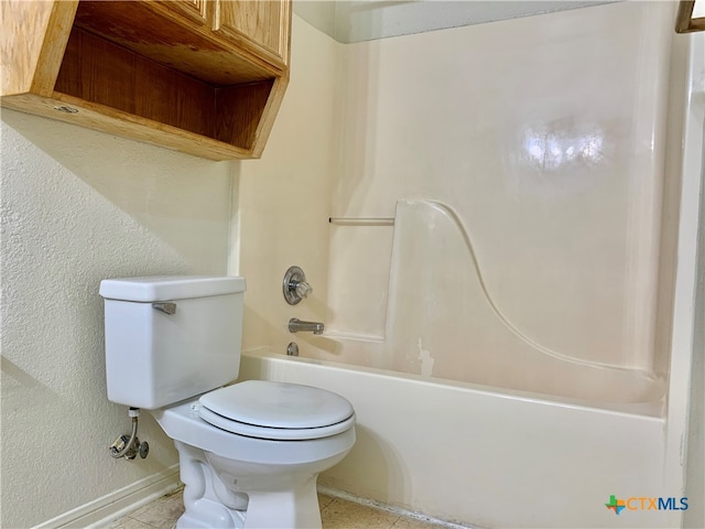 bathroom featuring bathing tub / shower combination, tile patterned floors, and toilet