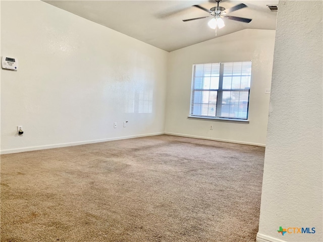 carpeted spare room featuring ceiling fan and lofted ceiling