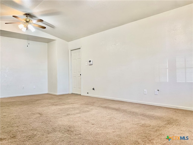 carpeted empty room featuring ceiling fan and lofted ceiling