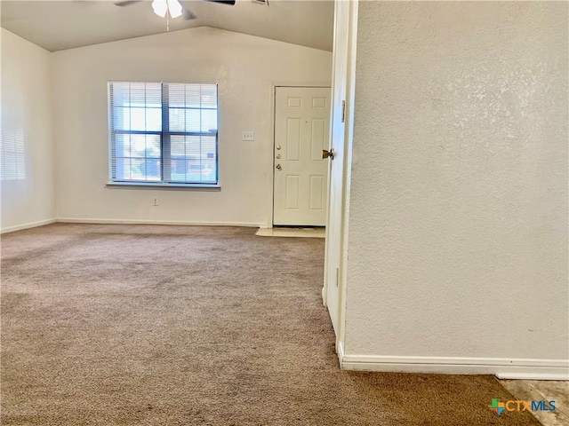 carpeted empty room with ceiling fan and vaulted ceiling