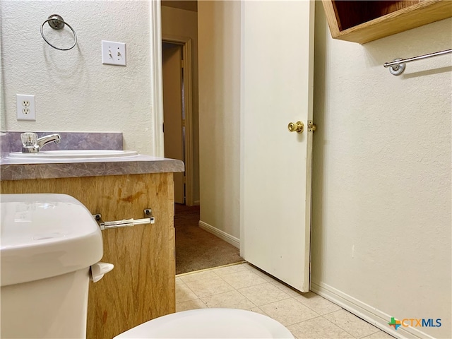 bathroom featuring tile patterned floors, sink, and toilet