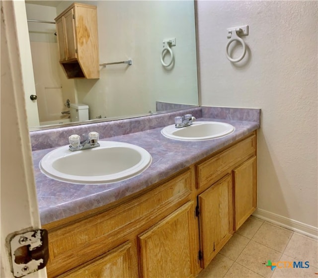 bathroom featuring tile patterned flooring, vanity, and toilet