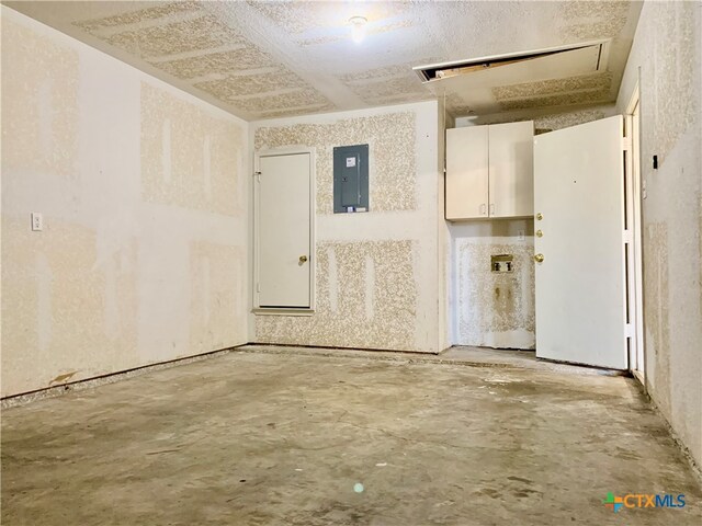 interior space featuring electric panel and concrete floors