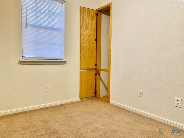 empty room with light colored carpet