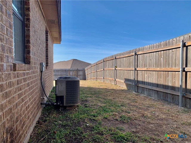 view of yard featuring central air condition unit