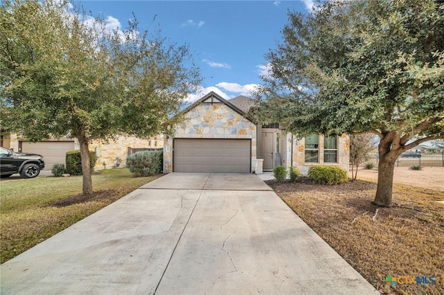 view of front of property featuring a garage and a front lawn