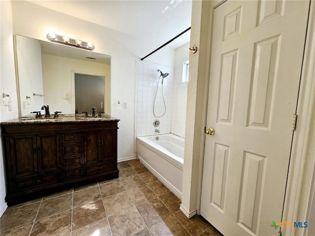 bathroom with vanity and tiled shower / bath