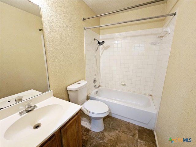 full bathroom featuring toilet, vanity, and tiled shower / bath