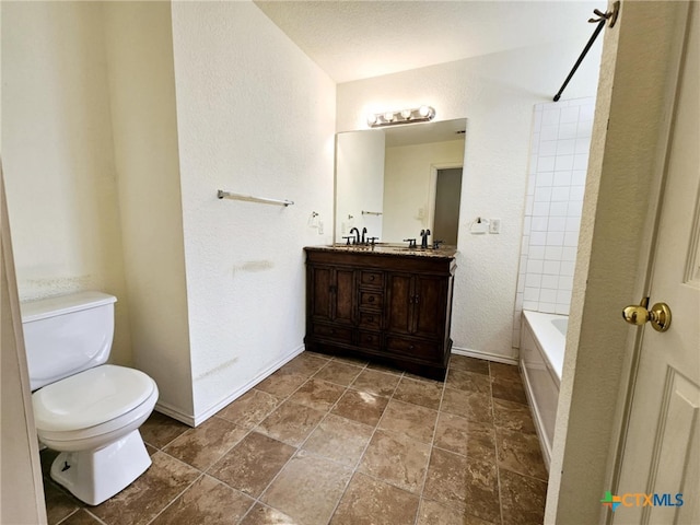 full bathroom featuring vanity, tiled shower / bath, and toilet