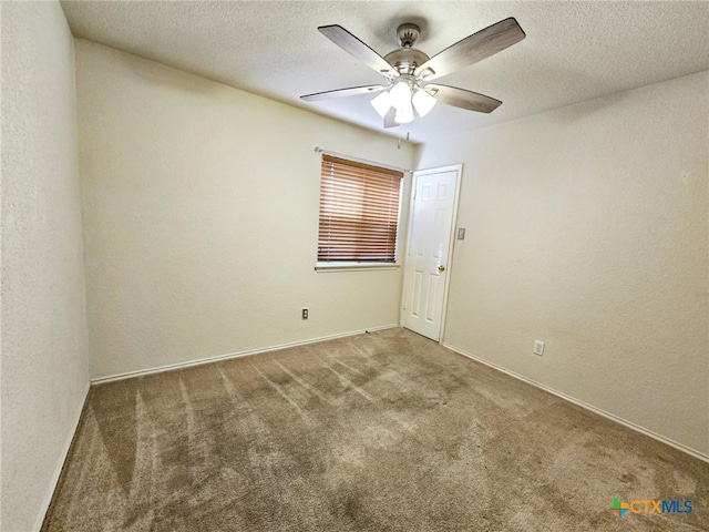 carpeted spare room featuring a textured ceiling and ceiling fan